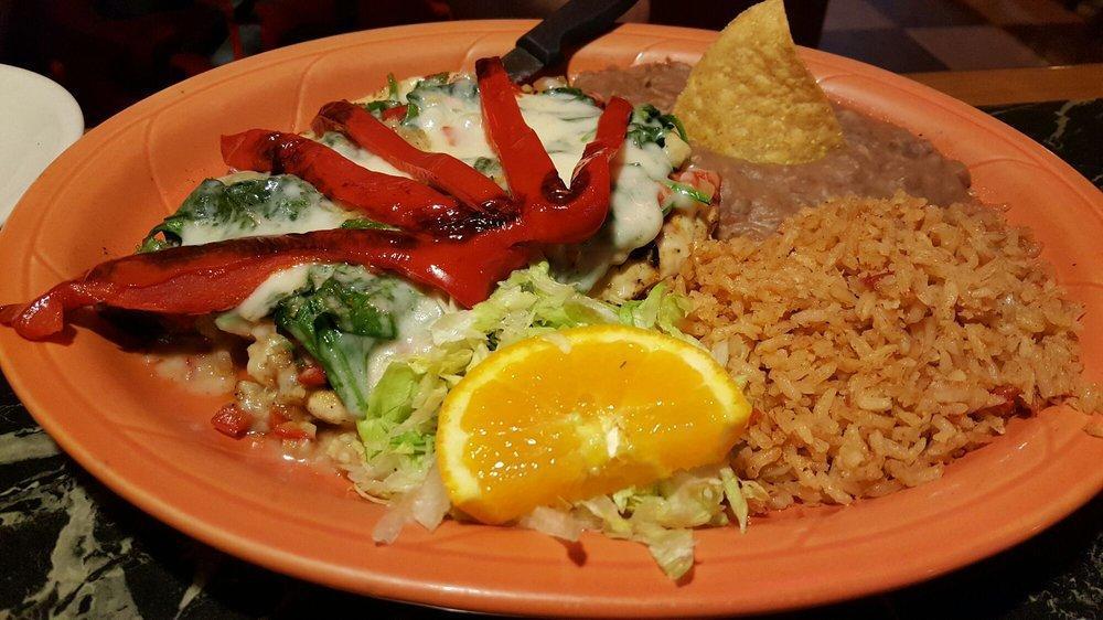 Spinach Enchiladas · 3 soft tortillas stuffed with spinach topped with tomato sauce, melted cheese and sour cream.