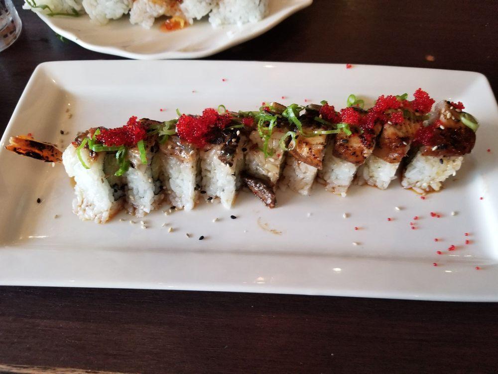 Golden Dragon Roll · Shrimp tempura, cucumber, cream cheese, topped with grilled fresh water eel, sweet soy sauce, red tobiko caviar, scallions and sesame seeds.