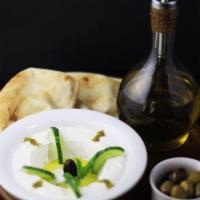 Labneh · Strained yogurt topped with zaatar and olive oil.