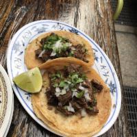 Carne Asada Tacos · Grilled soy (gf) chipotle marinated steak, chopped onion, and cilantro.