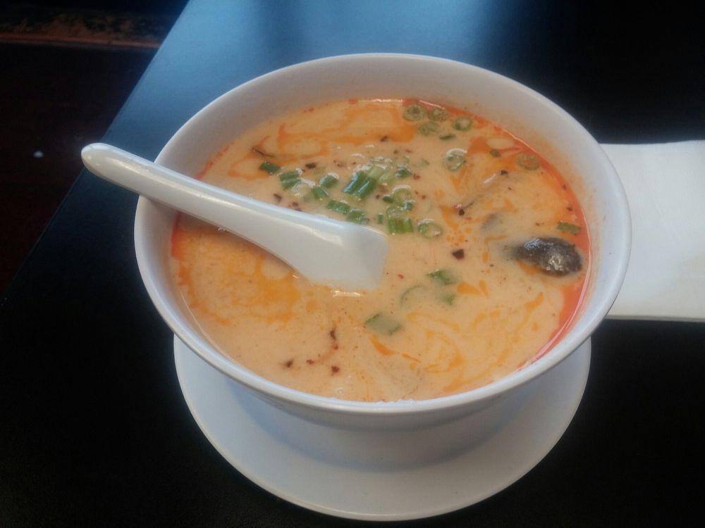 Tom Ka Soup · Hot and sour coconut soup with oil chili, surprising herbs, and mushroom.