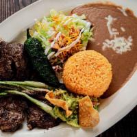 Carne Asada Lunch · Grilled flank steak served with rice, beans, a side salad and tortillas.