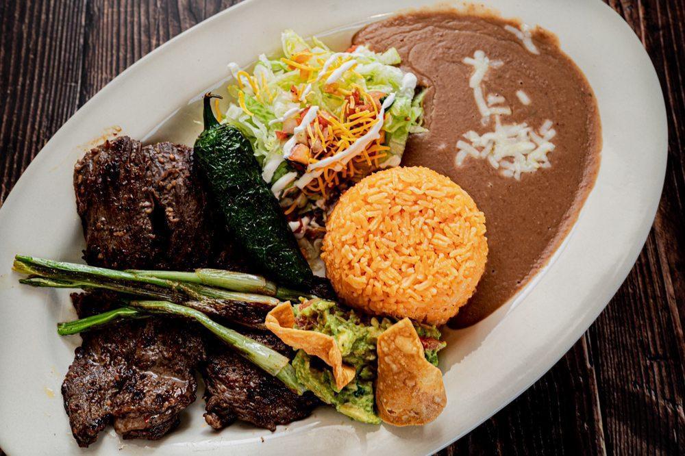 Carne Asada Lunch · Grilled flank steak served with rice, beans, a side salad and tortillas.