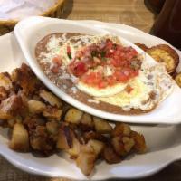 Huevos Rancheros · Refried beans, 2 eggs over medium, cheese, pico de gallo, homefries and tortillas.