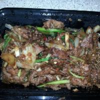 Mongolian Beef · Hot. Beef filets sauteed with scallions and ginger in a savory seasoned sauce with hot peppe...
