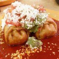 Chicken Chimichangas · Two fried flour tortillas stuffed with grilled chicken, Monterey and Chihuahua cheeses, and ...