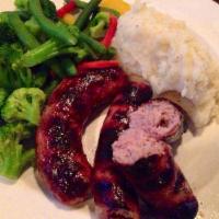 Bangers and Mash · Two English bangers with mashed potatoes and gravy.
