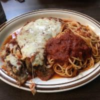 Eggplant Parmigiana · Breaded eggplant topped with marinara sauce and mozzarella cheese. Served with a side of spa...