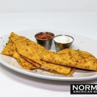 Quesadilla · A large flour tortilla stuffed with cheddar-jack cheese. Served with sour cream and salsa.