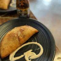 Pabellon Empanada · Shredded beef, black beans, white salty cheese and sweet plantains. 