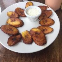 Tajadas · Sweet plantains with aged cheese. 