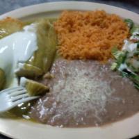 Tamales · Two tamales, side of rice and beans.