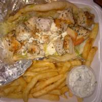 Chicken Souvlaki · Grilled chicken cubes served on pita bread with tzatziki sauce, onions and tomatoes. Come wi...