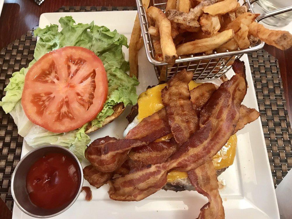 Applewood Bacon Cheeseburger · Angus burger, a stack of applewood bacon, vermont white cheddar, canadian cheddar, tomato, crispy leaf lettuce. Served on a toasted brioche bun, served with fries