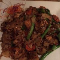 Pad Kee Mao · Flat noodles stir-fried with egg, jalapeno, green beans, onions, tomatoes and sweet basil le...
