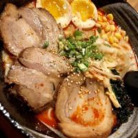 Tonkatsu Ramen · Japanese braised pork belly, cabbage, corn, egg, wakame, sesame, green onion.