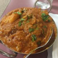 Lamb Vindaloo · Boneless leg of lamb cooked with potatoes and chilies in mughlai sauce. Served with basmati ...