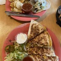 BBQ Chicken Quesadilla · Fresh grilled chicken tossed in smoky BBQ sauce, applewood bacon, shredded cheddar Jack chee...
