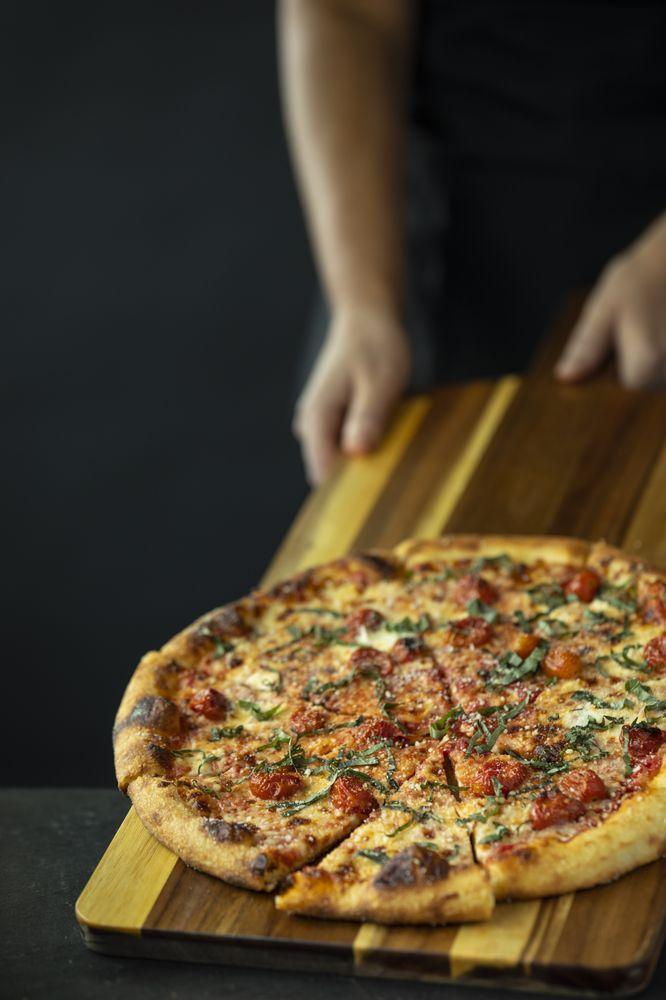 Margherita Pizza · Red sauce, fresh mozzarella, basil, grape tomatoes, and spin blend cheese.