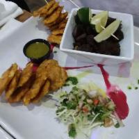 Tostones · Fried green plantains.