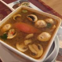 Tom Yum Soup · Hot and sour soup with chicken, tofu or shrimp, mushrooms, tomatoes, lemongrass, kaffir lime...