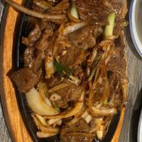Mongolian Beef · Stir fried beef with scallion, onion in a brown sauce. Hot and spicy.