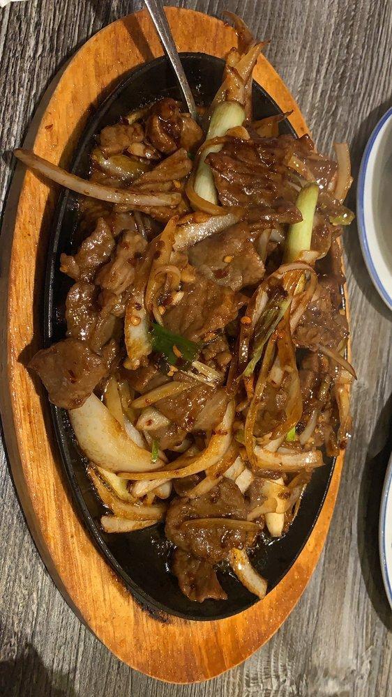 Mongolian Beef · Stir fried beef with scallion, onion in a brown sauce. Hot and spicy.
