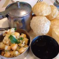 Pani Puri · Crispy wheat shells with potatoes and chickpeas filling. Served with spicy water.
