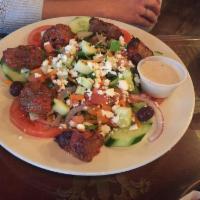 Greek Salad · Romaine, kalamata olives, feta cheese, red onion, carrot, cucumber and tomato. Served with G...