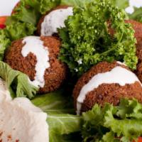 Falafel Plate · 5 pieces of falafel served with hummus, tahini, tomatoes, romaine lettuce, pickles and pita ...