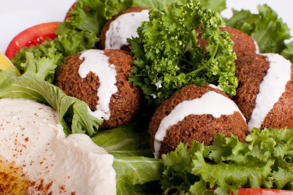 Falafel Plate · 5 pieces of falafel served with hummus, tahini, tomatoes, romaine lettuce, pickles and pita bread. Vegetarian.