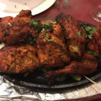 Tandoori Chicken · Chicken marinated in yogurt and freshly ground spices and then broiled in the tandoor. Serve...