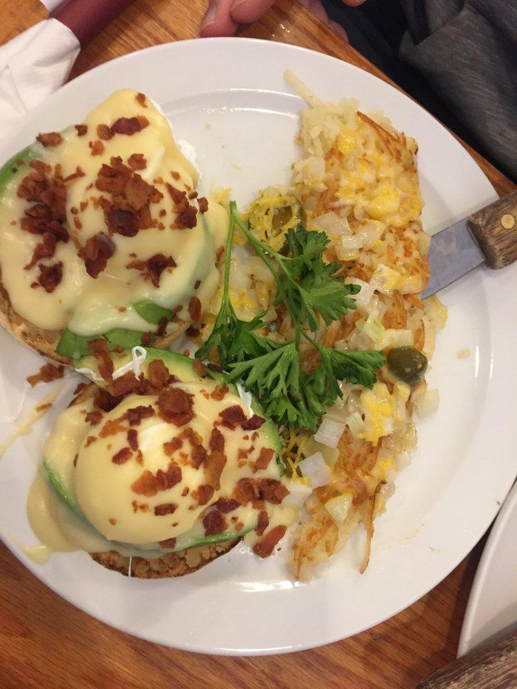 Avocado Benedict · Poached eggs with fresh avocado sliced served on a toasted Eenglish muffin. Topped with creamy hollandaise and crumbled bacon. Served with a breakfast side.
