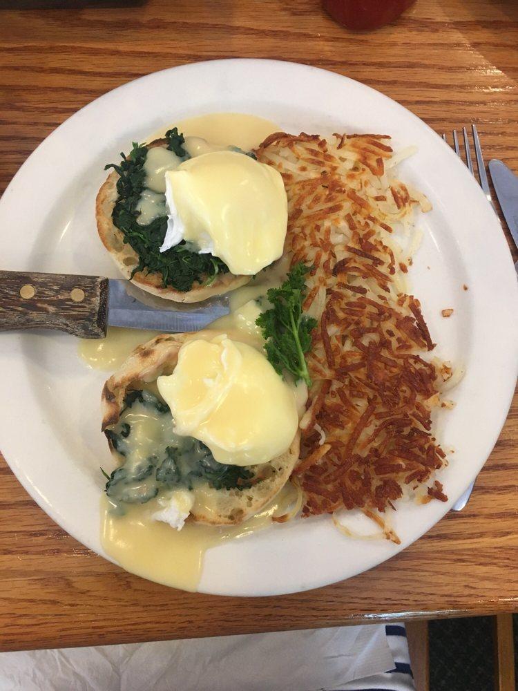 Eggs Florentine · Grilled spinach with poached eggs atop a toasted English muffin topped with hollandaise sauce.