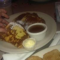 French Toast · Fresh sourdough bread dipped in egg wash, brushed with butter and sprinkled with powdered su...