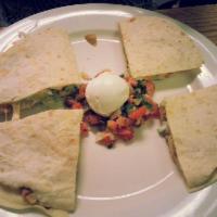 Quesadilla · Flour tortillas stuffed with choice of filling and cheese, served with tomatoes, sour cream,...