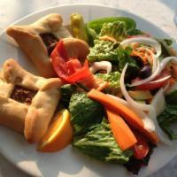 Spinach Pie Plate · Two spinach pies served with green salad.