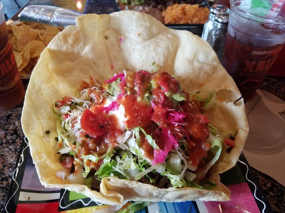 Super Taco Salad · Choice of meat or vegetarian, served in a large flour tortilla shell or barefoot in a bowl. Filled with beans, rice, lettuce, tomato, pico de gallo, salsa, cheese, guacamole and sour cream.