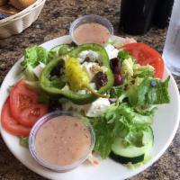 Greek Salad · Fresh romaine and iceberg lettuce, imported feta cheese, tomatoes, onions, cucumbers, Kalama...