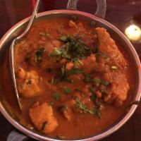 Chicken Curry · Cubes of chicken cooked with onions in an authentic Indian style curry sauce.