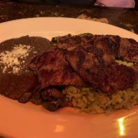 Carne Asada · Marinated flank steak grilled and served with grilled peppers and onions, refried black bean...