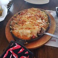 Queso Fundido · Onions, tomatoes, peppers, minced garlic, Jack cheese and chipotle crema. Gluten free and ve...
