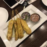 Chicken Satay · Skewered chicken marinated and slow grilled, served with peanut sauce and cucumber sauce.