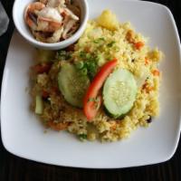 Pineapple Fried Rice · Jasmine Thai rice stir-fried with shrimp, chicken, fresh pineapple, cashew nuts, raisins, on...
