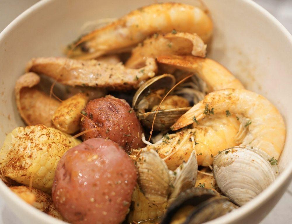 Karai Combo · Our version of a Clam Bake that includes Whole Shrimp, Clams, Mussels, Potato, Corn, and Local Pineapple Kukui Sausage.