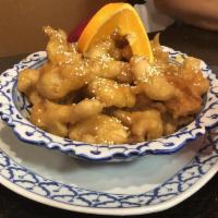 Orange Chicken · Breaded chicken, tossed with sesame seeds, and served with sweet and sour sauce.
