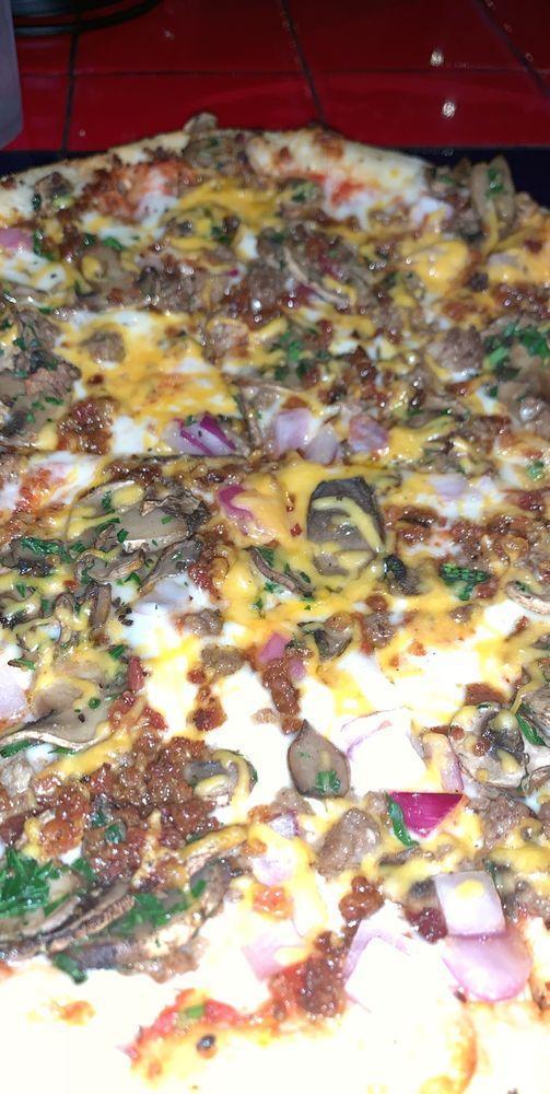 Bacon Cheeseburger Pizza · Pizza sauce, house cheese blend, seasoned ground beef, red onions, mushrooms, cayenne-candied bacon and cheddar.