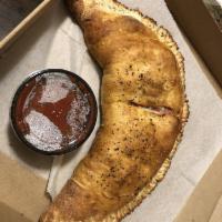 Calzone · Made with our house cheese blend and creamy ricotta, folded into our homemade pizza dough sh...