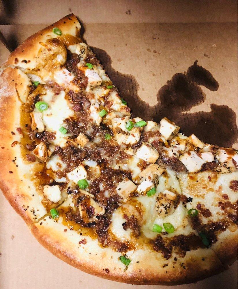 BBQ Chicken Pizza · Smokey BBQ sauce, house cheese blend, seasoned chicken green onions and cayenne-candied bacon.