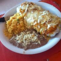Burrito Suizo Dinner · Burrito with melted cheese and ranchero sauce on top. Served with beans, cheese, lettuce, to...